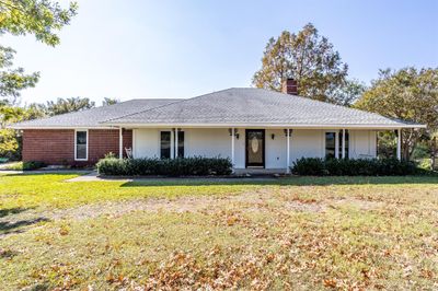 Country living. Enjoy the swing on the front porch and watch the sunrise. | Image 1