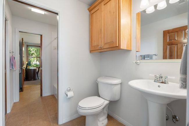 Full bath featuring toilet, baseboards, tile patterned flooring, and bathing tub / shower combination | Image 28