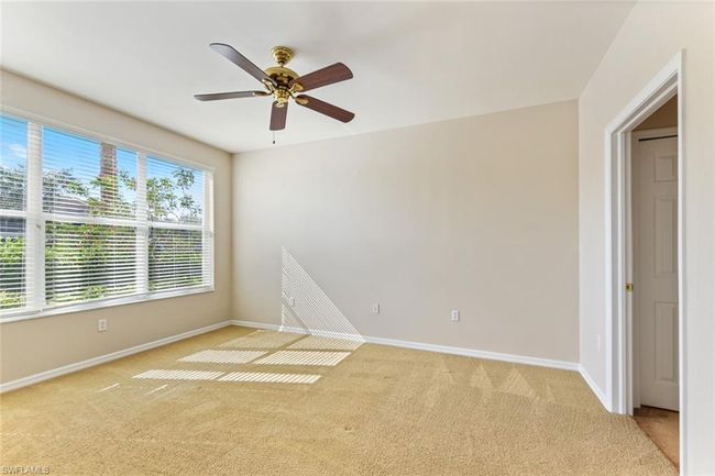 Spare room with baseboards, ceiling fan, and light colored carpet | Image 22