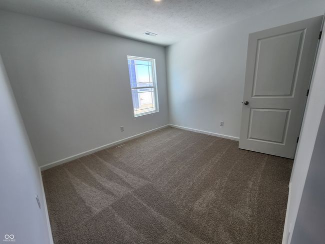 unfurnished bedroom with baseboards and carpet | Image 7