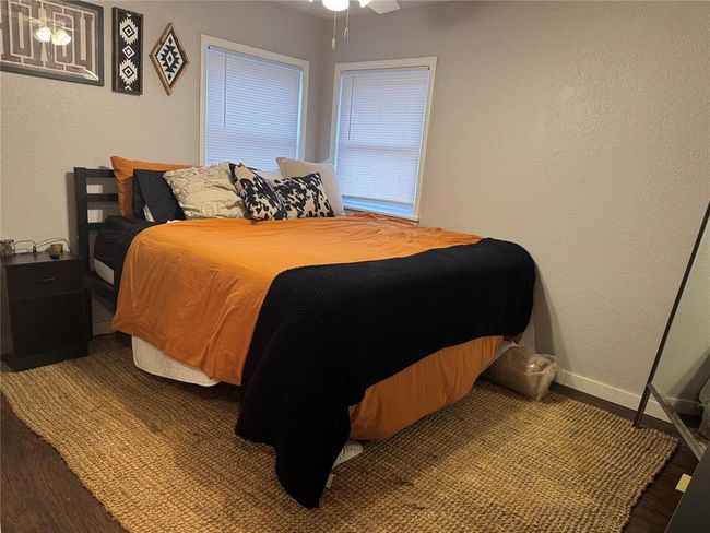 Bedroom with wood-type flooring and ceiling fan | Image 16