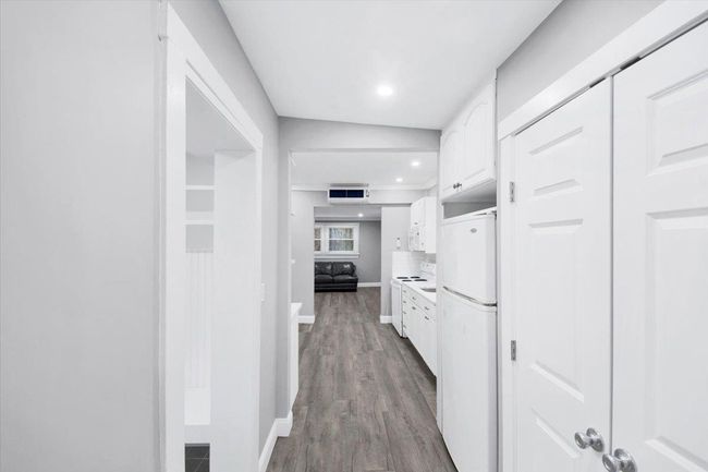 Corridor featuring baseboards, wood finished floors, and recessed lighting | Image 6