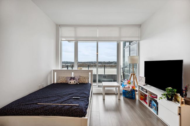 Bedroom featuring expansive windows and wood finished floors | Image 12