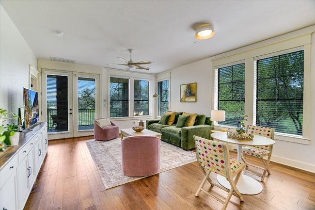 Living area featuring plenty of natural light, ceiling fan, and hardwood / wood-style floors | Image 4