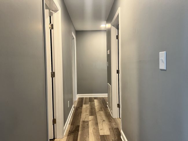 Down the hall to the laundry room and two bedrooms | Image 6
