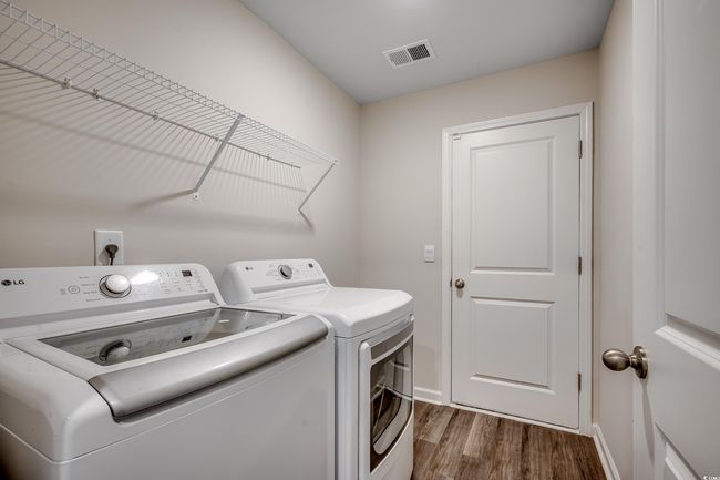 Clothes washing area with laundry area, separate washer and dryer, visible vents, baseboards, and dark wood-style floors | Image 28