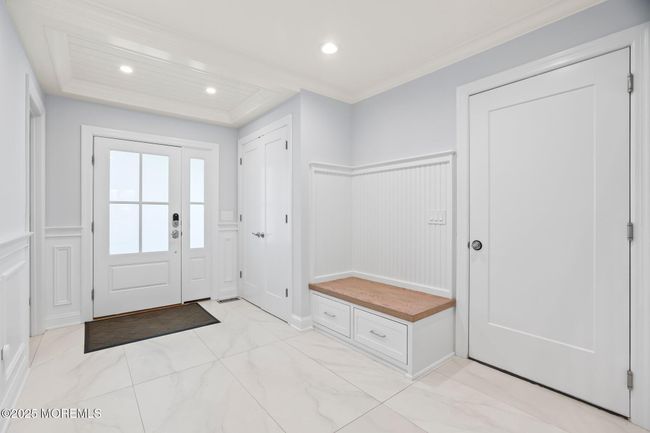 front door, foyer, built ins, access to garage | Image 5