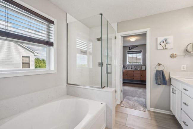 Primary bath features recently tiled walk-in shower | Image 22