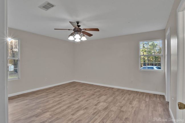Empty room featuring ceiling fan and light wood-type flooring | Image 18