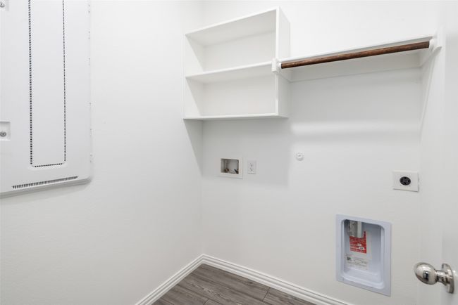 Washroom with electric dryer hookup, baseboards, wood finished floors, gas dryer hookup, and washer hookup | Image 20