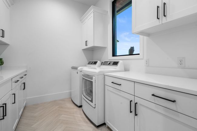 Laundry area with separate washer and dryer, cabinet space, and healthy amount of natural light | Image 30