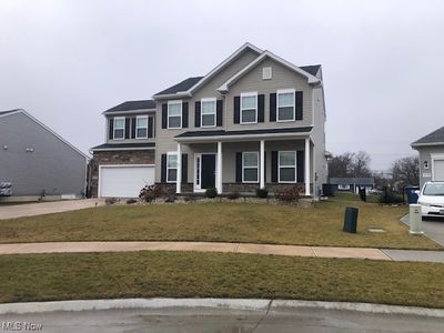 View of front facade featuring a garage, a front yard, and a porch | Image 2