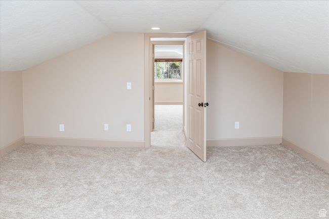 Additional living space with lofted ceiling, carpet, and a textured ceiling | Image 36