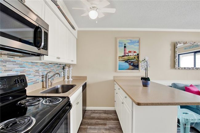 Full Sized Kitchen with Stainless Steel Appliances, Ceiling Height Cabinets, Island with Barstool Seating & Pantry. | Image 11