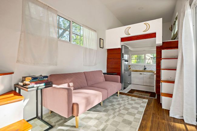 Living area with high vaulted ceiling and dark wood-style floors | Image 25