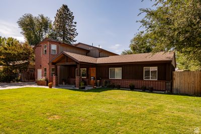 Back of property with a lawn and a patio | Image 2