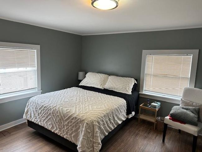 Bedroom featuring ornamental molding, multiple windows, and dark wood-type flooring | Image 7