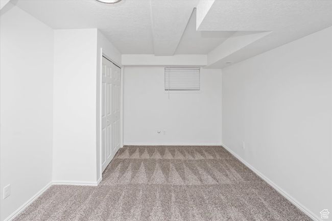 Spare room with baseboards, carpet, and a textured ceiling | Image 30
