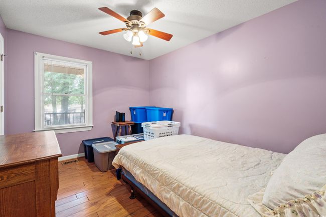Bedroom featuring light wood-type flooring, a ceiling fan, and baseboards | Image 16