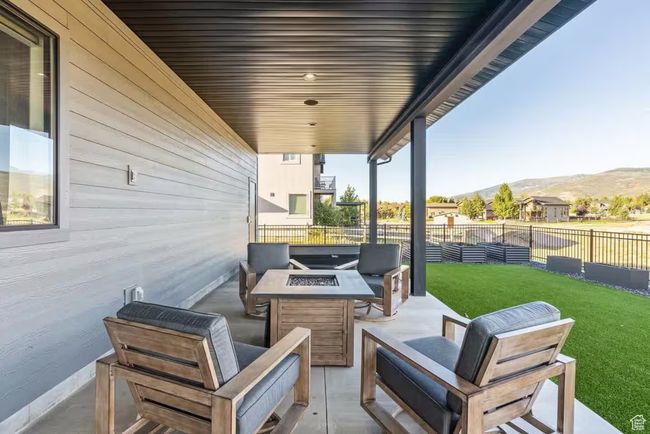 View of patio / terrace featuring an outdoor living space with a fire pit, fence, and a mountain view | Image 39