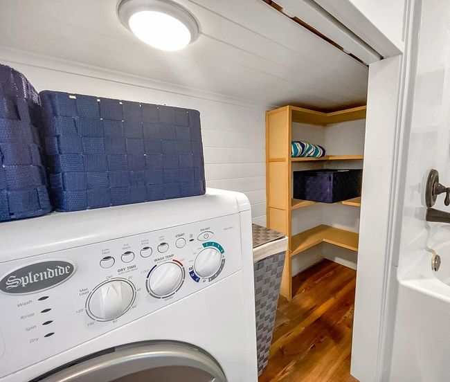 Laundry room featuring washer / clothes dryer and wood finished floors | Image 31