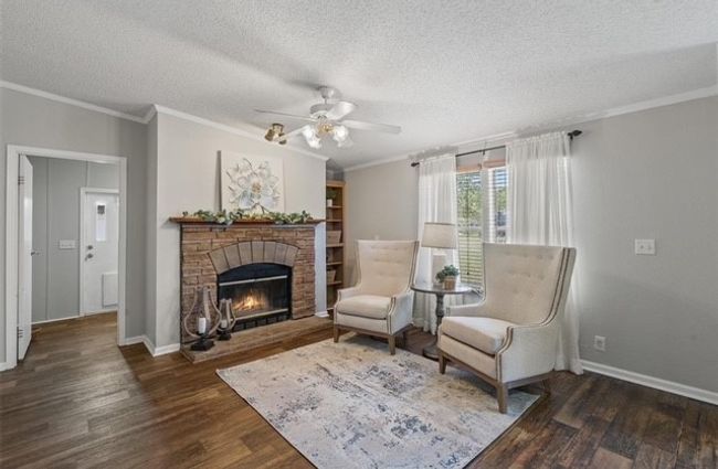 Secondary living room featuring a stone fireplace | Image 26