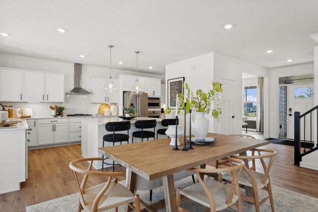(Photo of a decorated model, actual homes finishes will vary) Soaked in natural sunlight, the homes eat-in dining room has ample space for a dining table located in the heart of the home. | Image 5