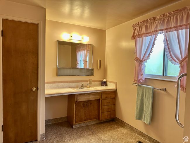 Bathroom with vanity and ample closet space | Image 12