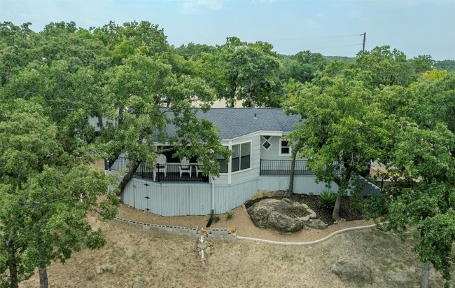 Rear view of property with roof with shingles and a wooden deck | Image 13