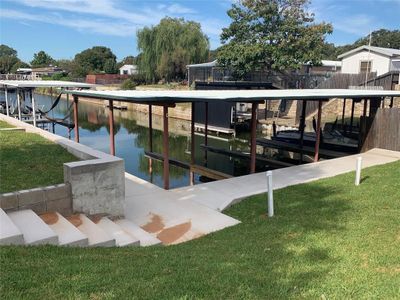 View of dock with a yard and a water view | Image 1