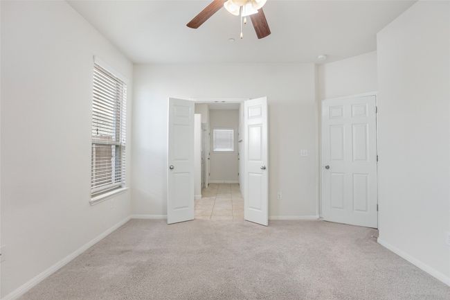 Unfurnished bedroom with baseboards and light carpet | Image 11
