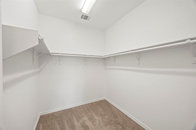 Walk in closet featuring carpet | Image 26
