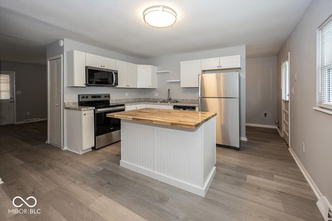 Updated Kitchen with New Stainless Steel Appliances, Island with Butcher Block Countertop & New LVP Flooring | Image 8