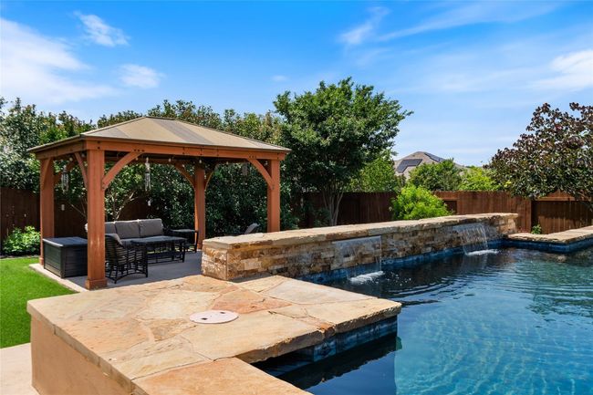 Backyard Oasis with Sparkling Pool, Pergola, and Outdoor Kitchen | Image 36