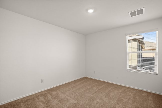 Carpeted empty room featuring visible vents | Image 23
