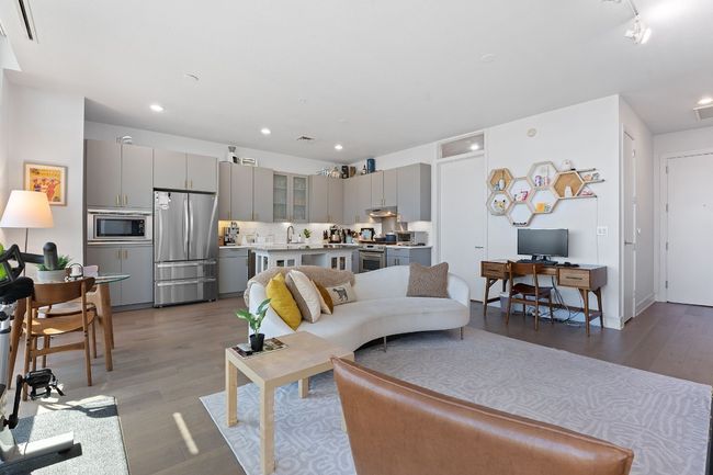 Modern updates include wide plank white oak flooring, stylish kitchen finishes and high-end appliances. | Image 7