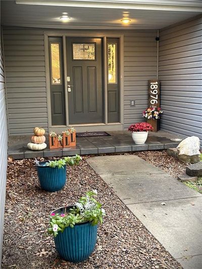 Front angle of the property featuring a front lawn, privacy fence on corner lot with open acreage beind and beside with beautiful country views. | Image 3