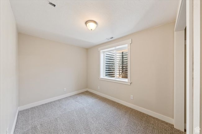 Unfurnished room featuring carpet floors, visible vents, and baseboards | Image 43