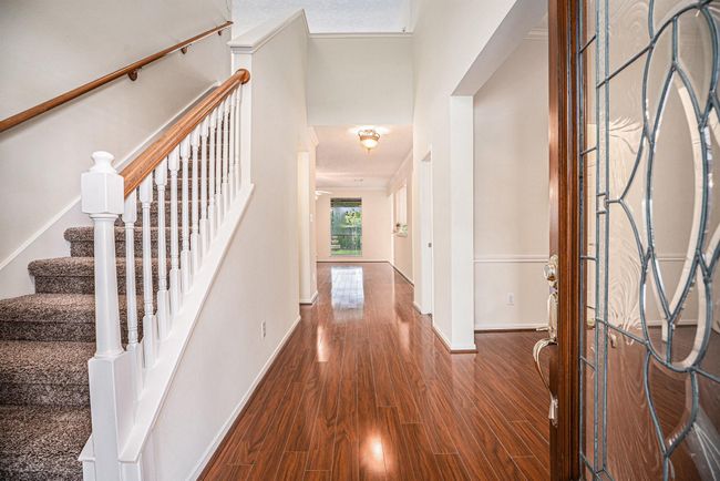 Entry way with stairs to left, formal dinning to the right. | Image 6