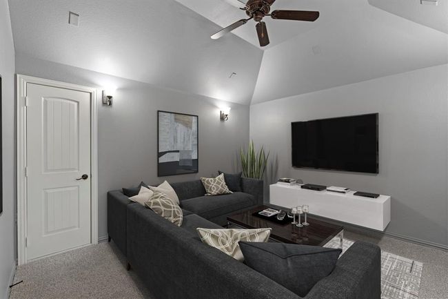 The home theater boasts high ceilings, a ceiling fan for added comfort, and elegant wall sconces for perfect lighting, creating an immersive and cozy viewing experience. *Virtually Staged* | Image 15