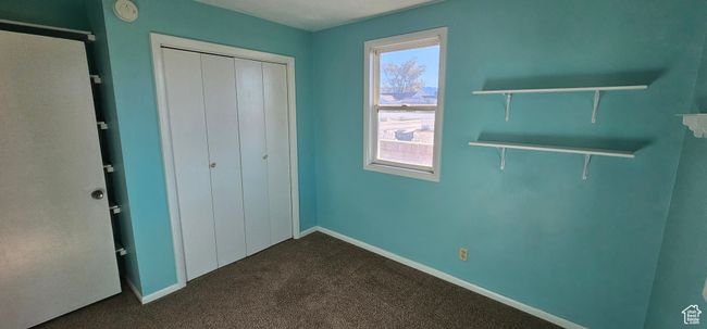 Unfurnished bedroom with carpet flooring and a closet | Image 25
