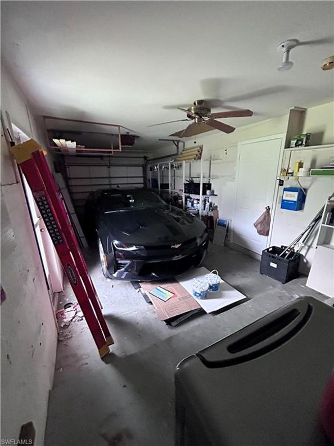 Garage featuring a garage door opener and ceiling fan | Image 9