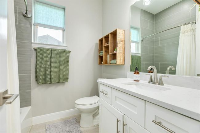 Secondary bathroom features atub/shower combo and long vanitywith plenty of counter space. | Image 27