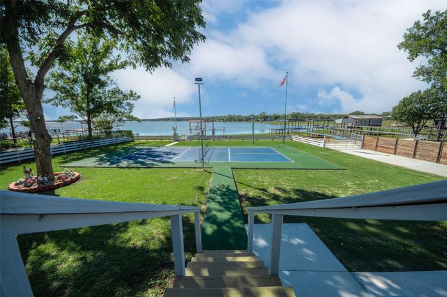 View of tennis court with a water view | Image 4