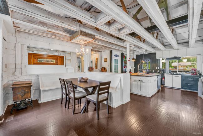 Dining space with a chandelier and dark wood-style floors | Image 4