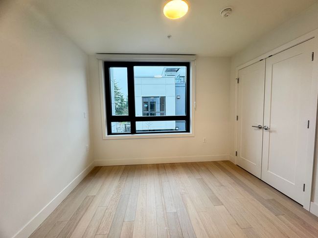 Unfurnished bedroom with baseboards, a closet, and light wood-type flooring | Image 39