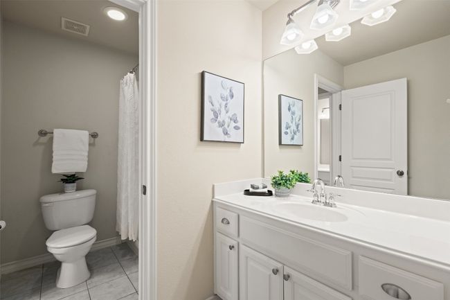 Conveniently designed for shared use, this Jack and Jill bathroom connects two bedrooms, offering double vanities and a well-thought-out layout that ensures privacy and functionality. | Image 32
