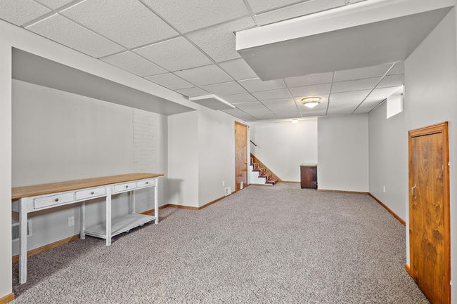 The basement with the stairs leading to the main floor visible beyond. | Image 14