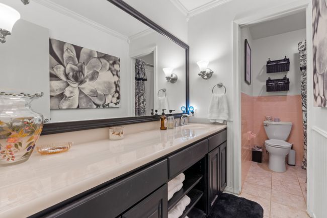 Hall Bathroom with long vanity, tile walls, tile patterned flooring, and toilet | Image 20