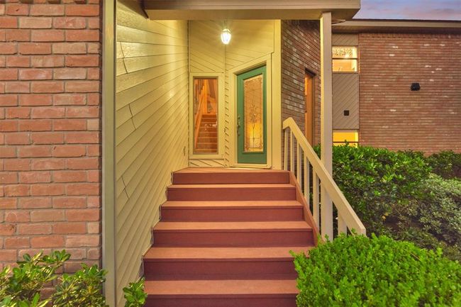 A charming covered front porch and elegant cut glass front door create a welcoming first impression. | Image 6